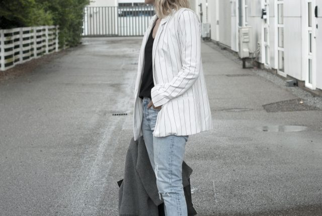 Style: pinstriped blazer and blue jeans.